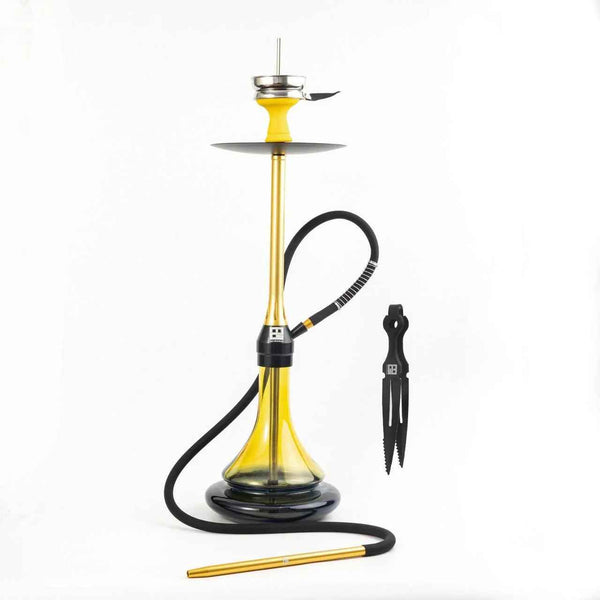 Modern gold and black hookah with glass base, hose, and tongs on white background