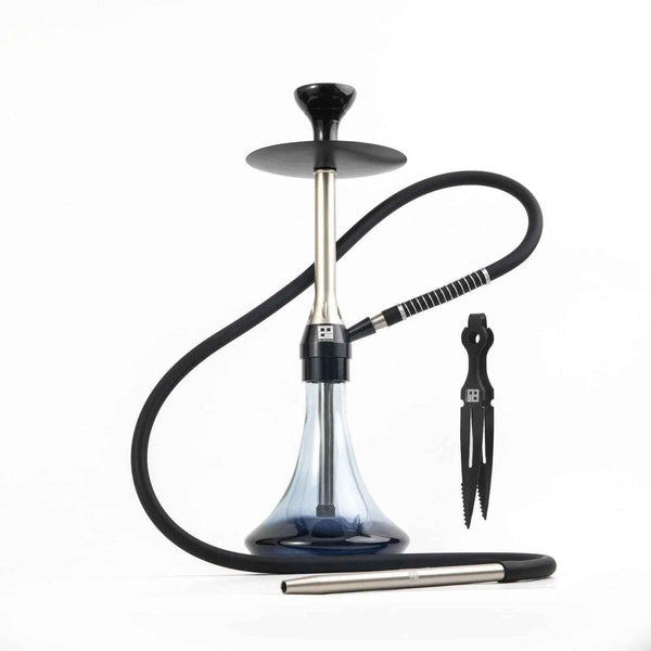 Modern gunmetal shisha pipe with clear glass base, black hose, and metal tongs on white background.