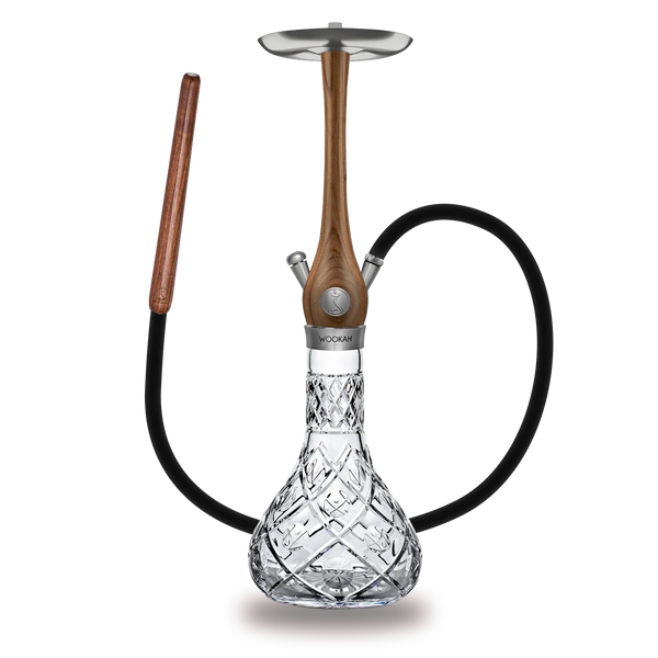 Luxury hookah with carved wooden stem, crystal glass base, and black hose on white background
