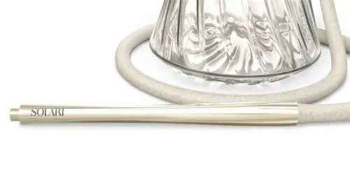 Elegant glass hookah with white silicone hose and metallic Solaris mouthpiece on white backdrop